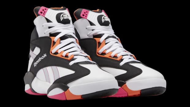 View of white, black, and orange Reebok sneakers.